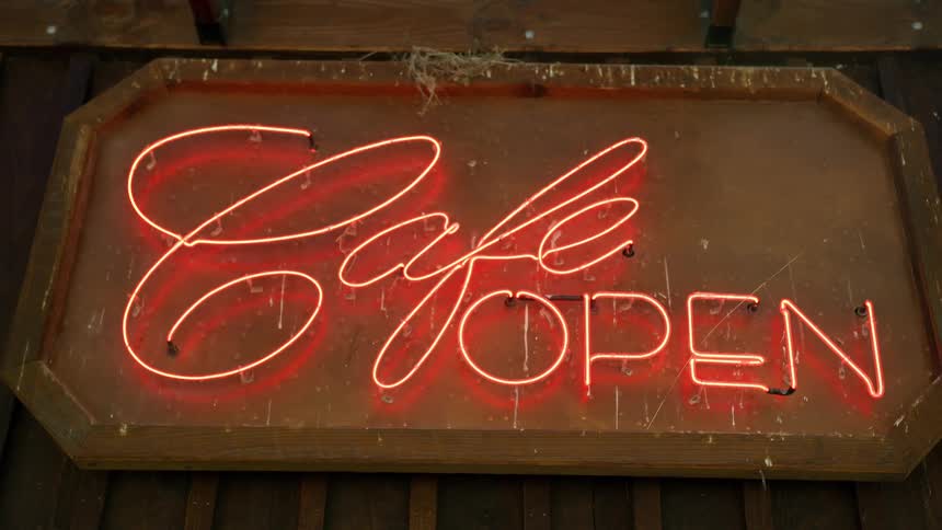 A sign with neon lights on the wall