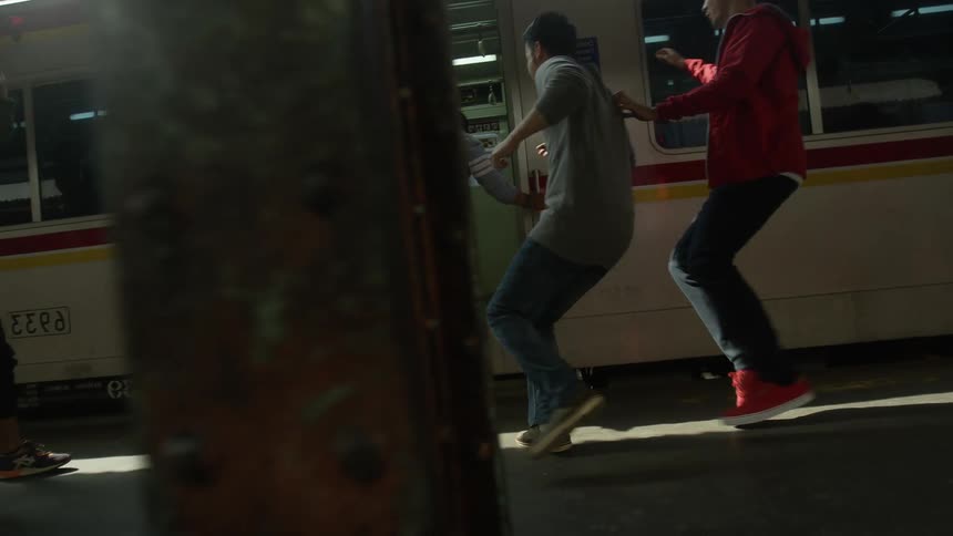 A group of teenage boys run to get on a train