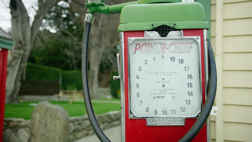 A meter is next to a house with a very green yard