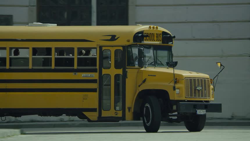 A school bus takes a right turn at an intersection