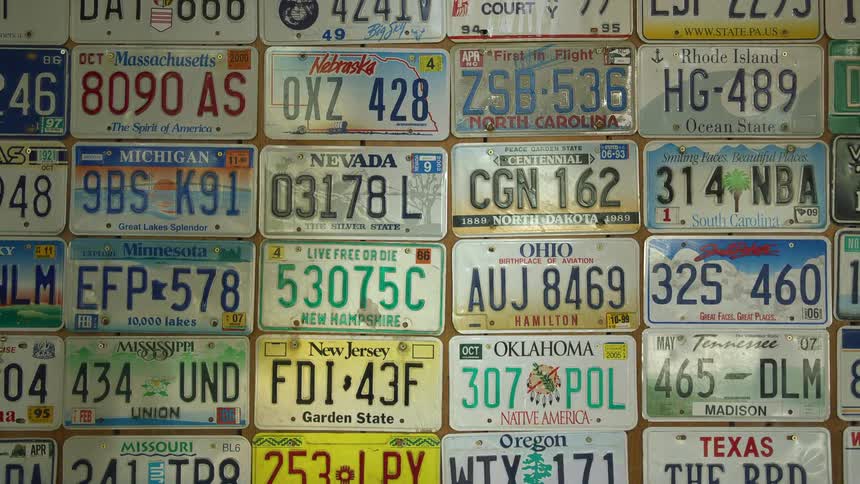A bunch of license plates being used as wall art