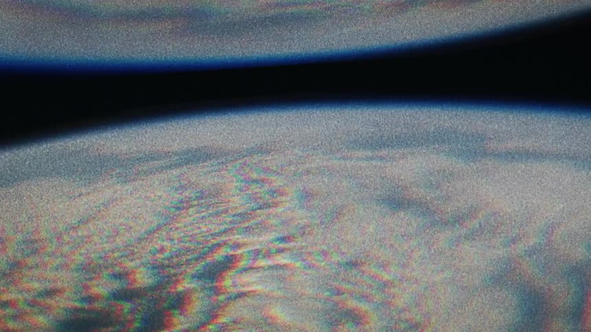 A planet appears mirrored as it rotates in space