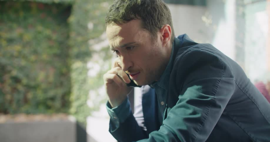 A man using a phone and a laptop