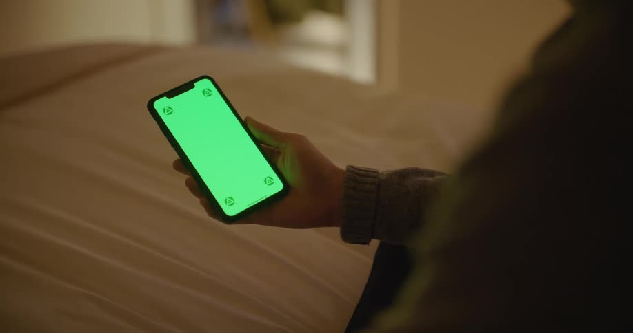 A person is using their cell phone at home