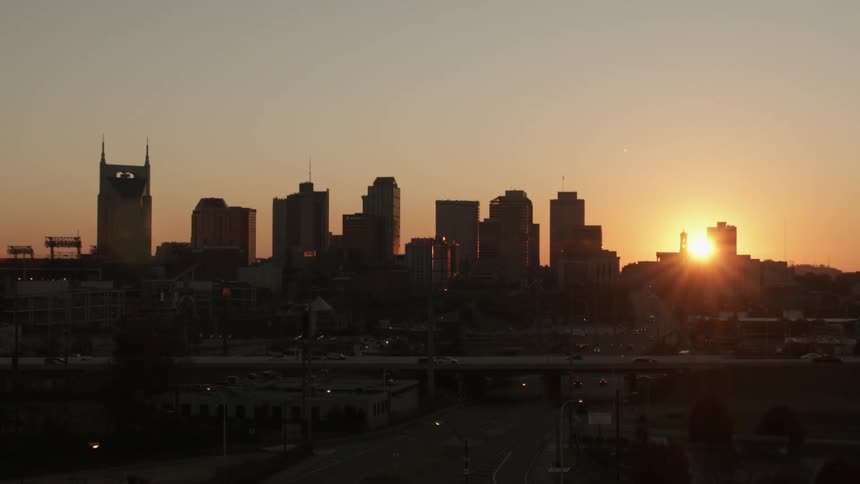 The sun sets over a city