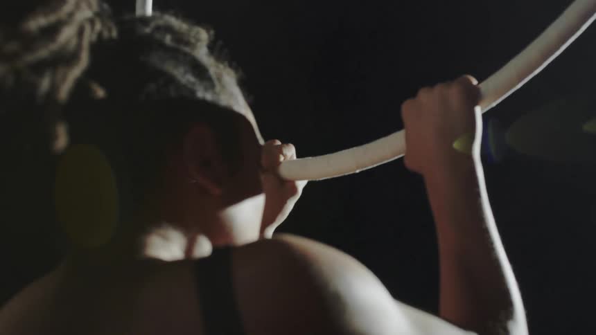 A woman is performing gymnastics on a ring
