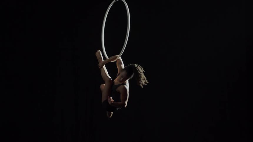 A woman doing gymnastics with a large ring