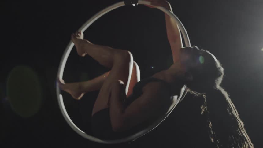 A woman sitting in a ring spinning around