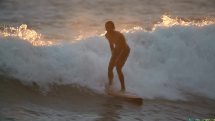 A man is riding a large wave in the ocean