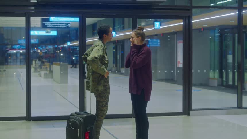 A woman greeting her servicemember partner at an airport