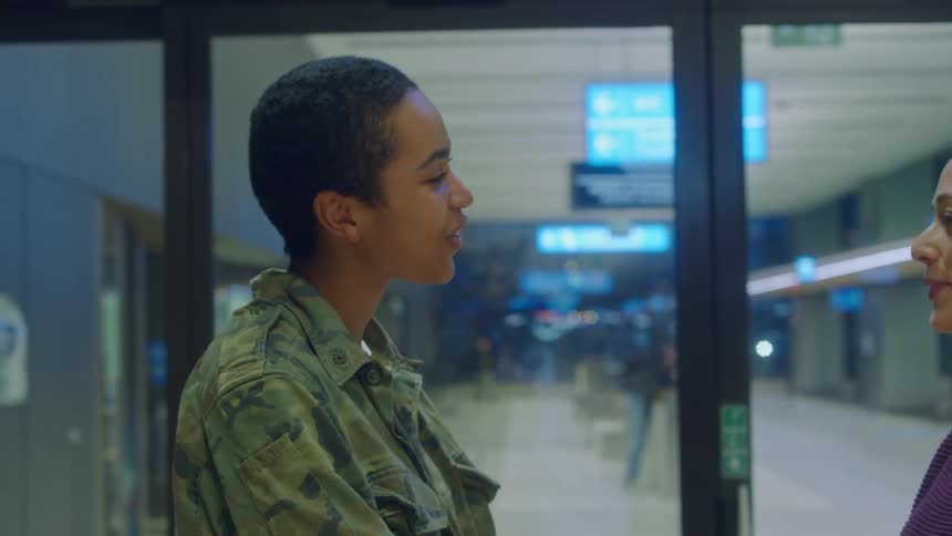 Young couple talking lovingly on the entrance of an airport terminal