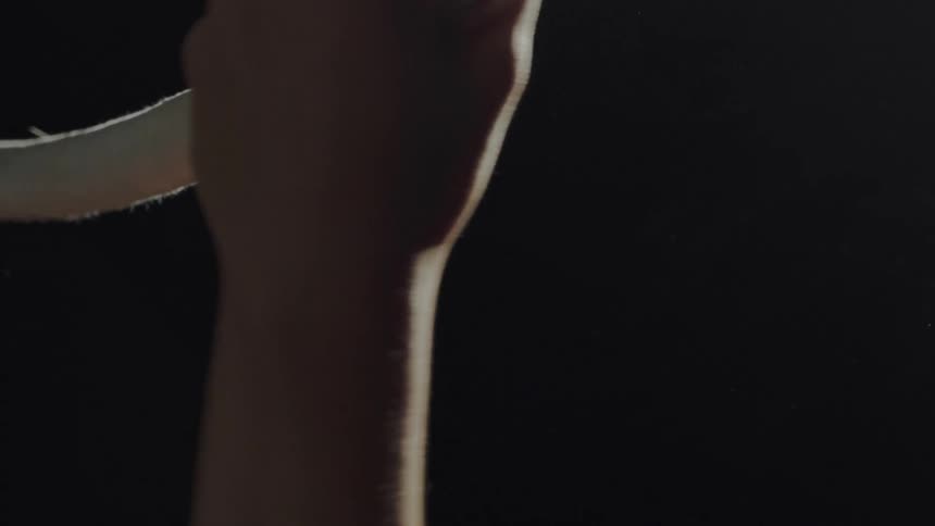 A view of a person holding onto a ring in a gymnastics studio