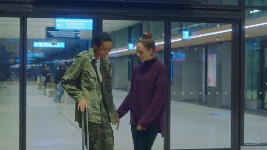 Two women walking in an airport together