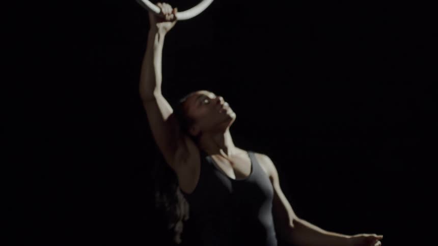 A woman doing gymnastics with a ring