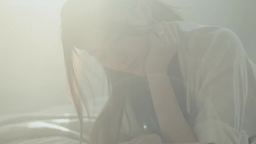 A woman is reading a book in bed