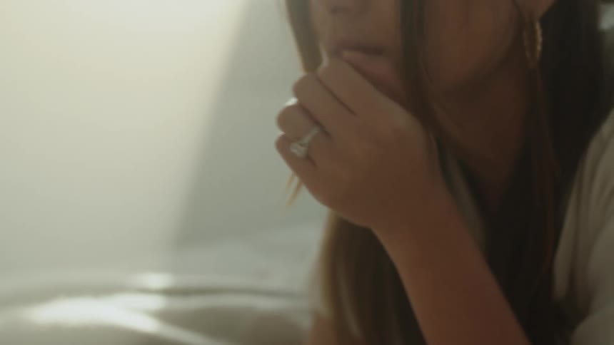 A woman laying on a bed relaxing