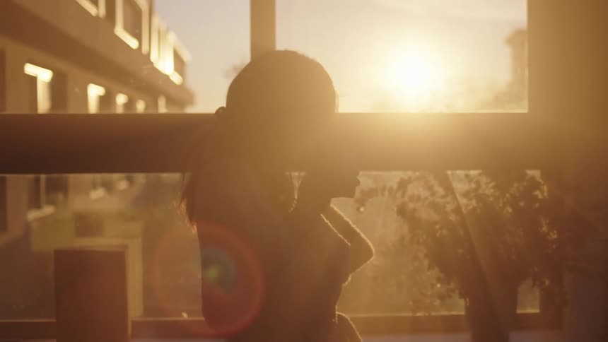 A woman standing in front of a window