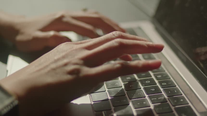 Woman typing on laptop