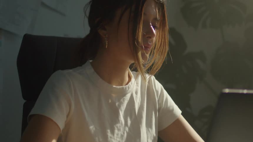A woman is typing on her keyboard