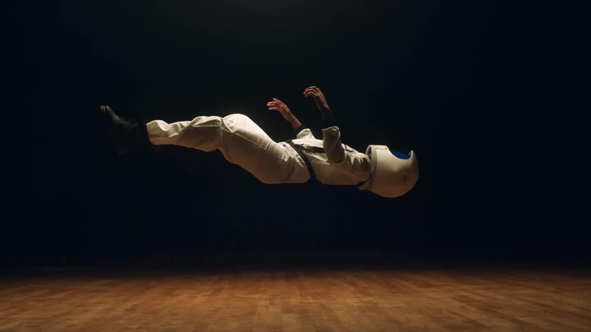 An astronaut in a space suit suspended in the air