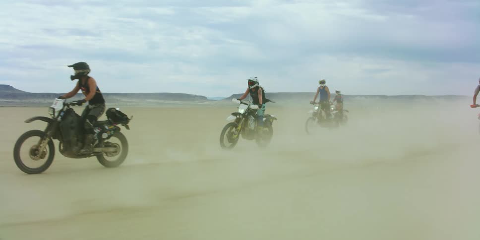 A group of people that are riding motorcycles outdoors