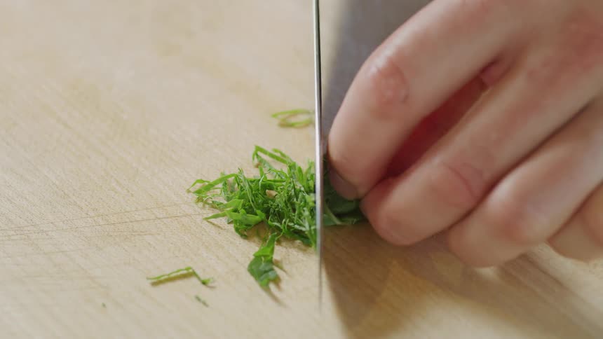 A close up of a person cutting greens