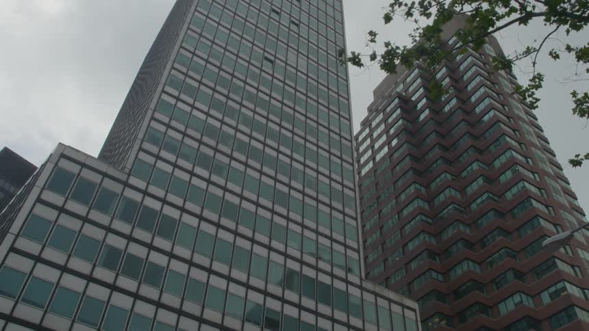 Tall buildings line a cloudy city sky