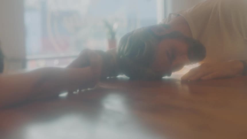 A male and female couple perform an interpretive dance while stretched across the floor