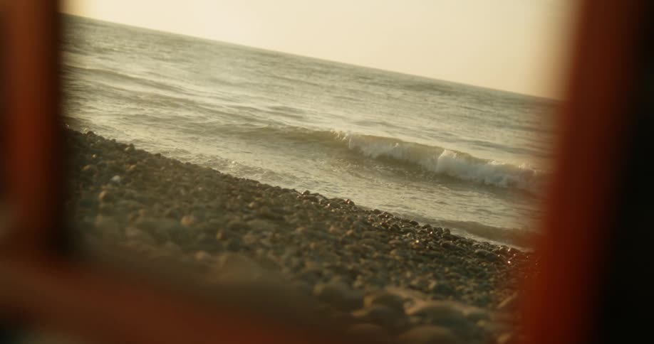 Waves crashing on to rocks on the beach