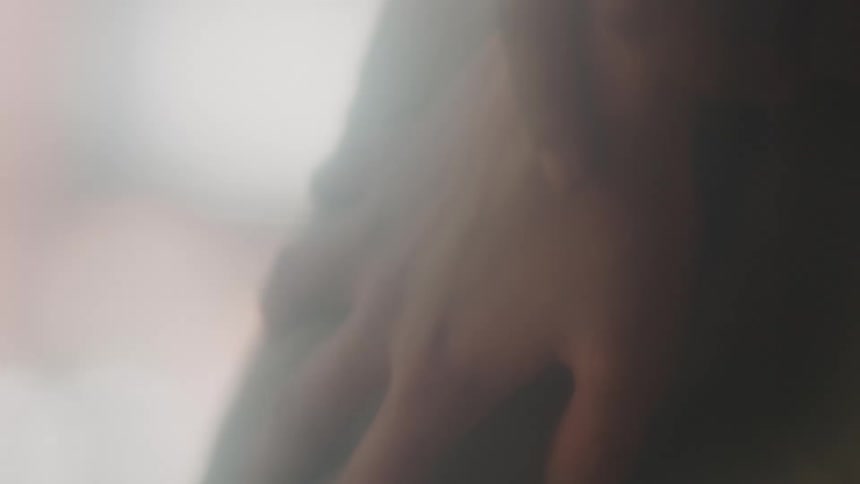 The hand of a woman resting on her clothing