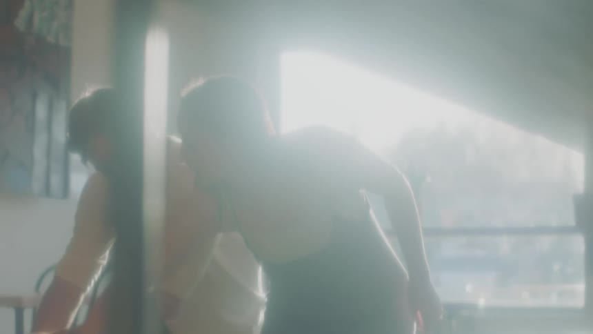 A man and woman practice dance moves together