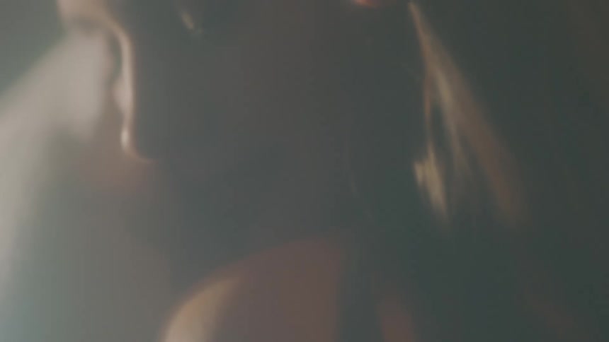 A person caressing a womans hair