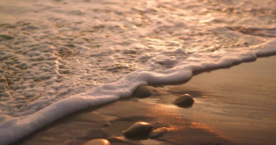 A close up of ocean water flowing on a beach