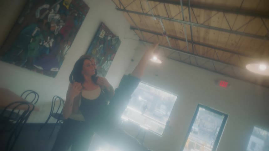 A man and woman dance in the shop
