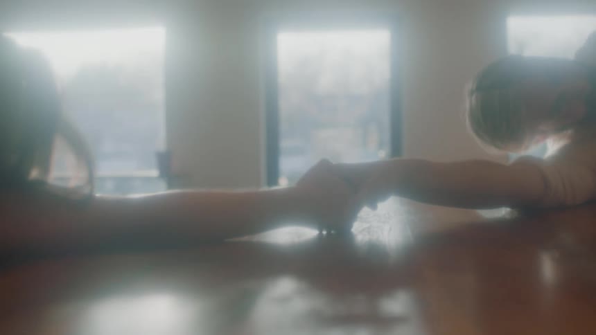 Young couple of interpretative dancers performing over a table inside a room at morning