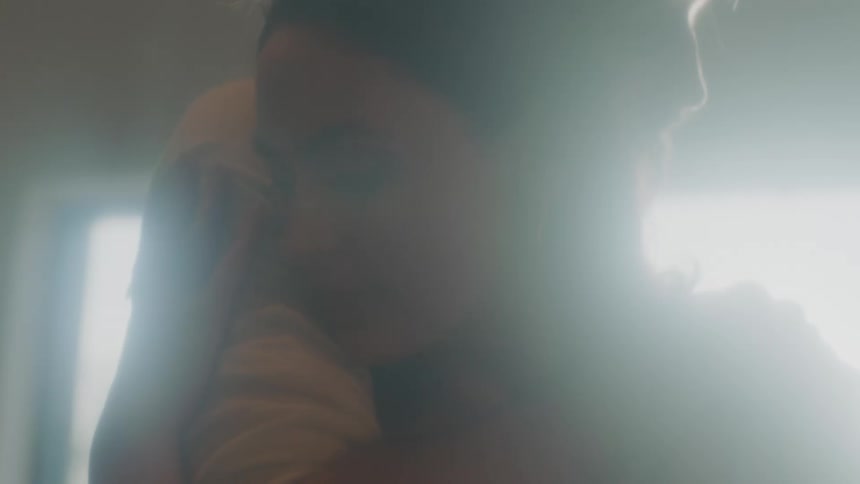 A woman standing and being hugged