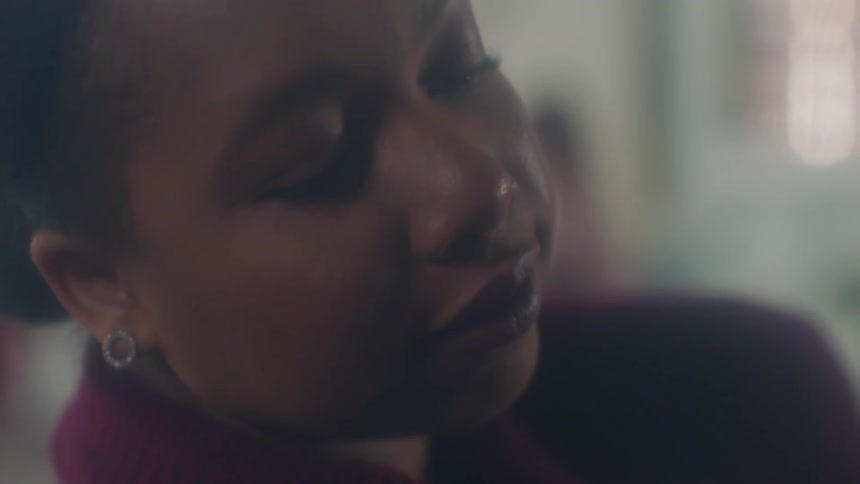A black woman sleeps while sitting up