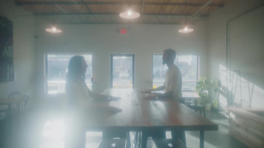 Two people putting there heads on tables