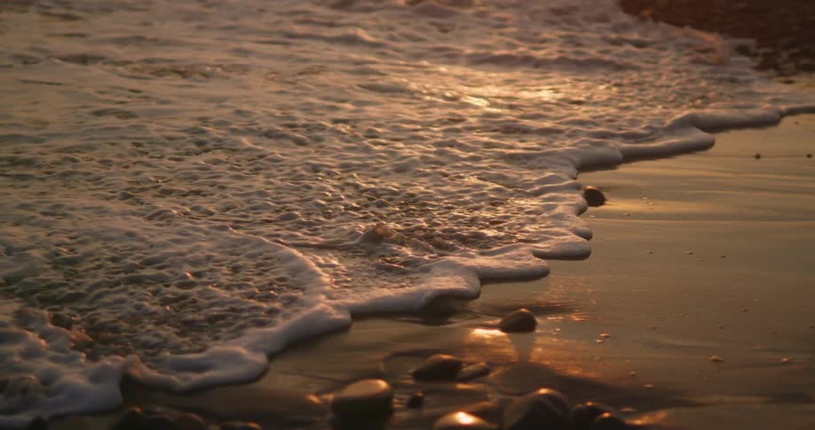 A view of a wave rolling up onto the beach