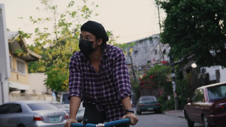 A man riding a bicycle outdoors down a road