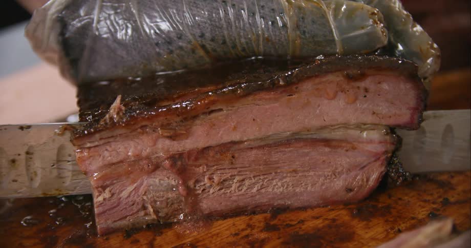 A close up of steak being cut