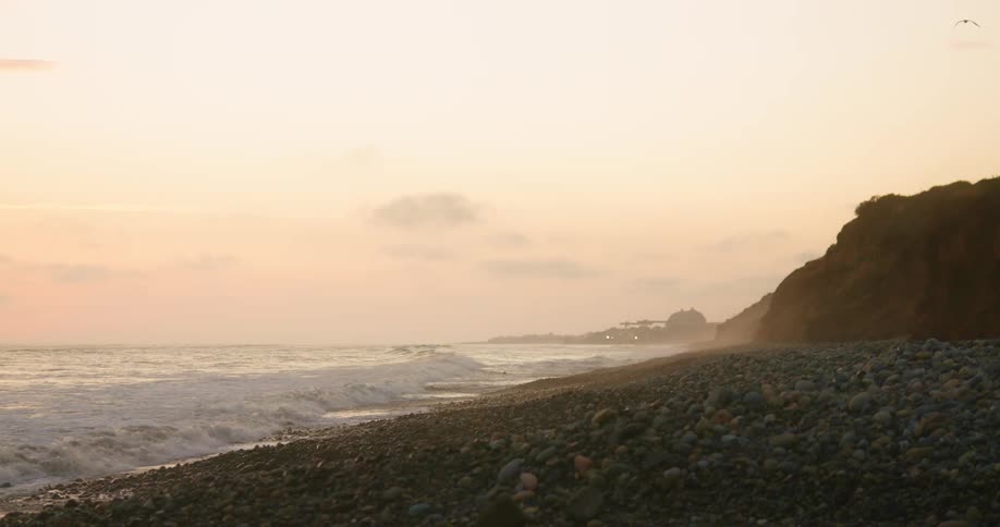 A coast with rocks and waves with the sky and clouds in the background