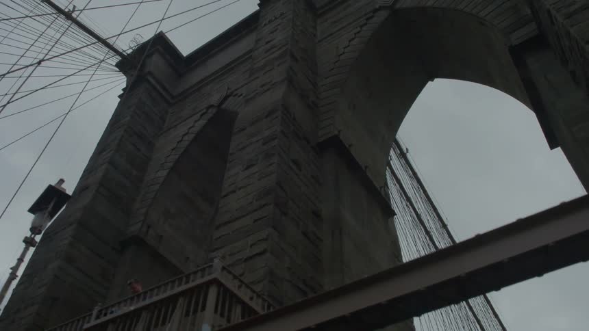 View of cables and arches while travelling on a bridge