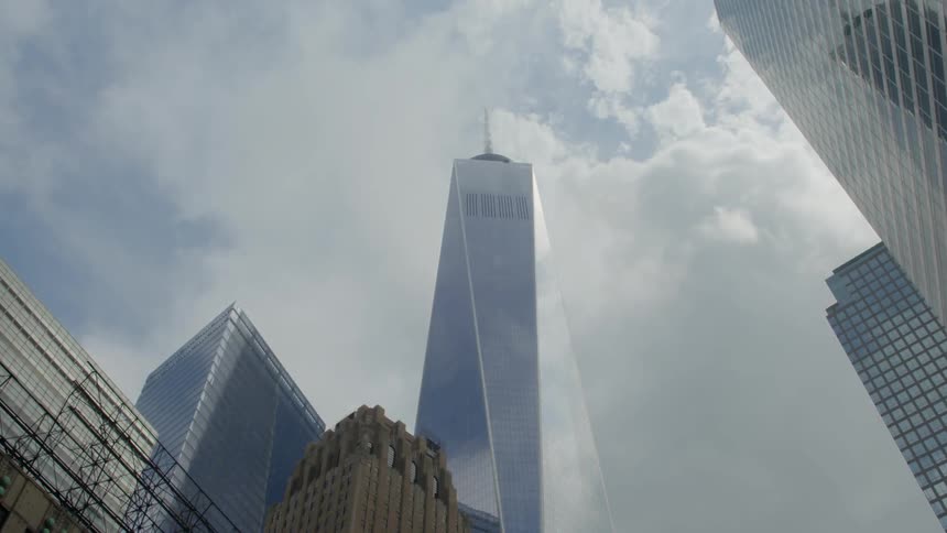 Tall buildings stand out against a cloudy sky
