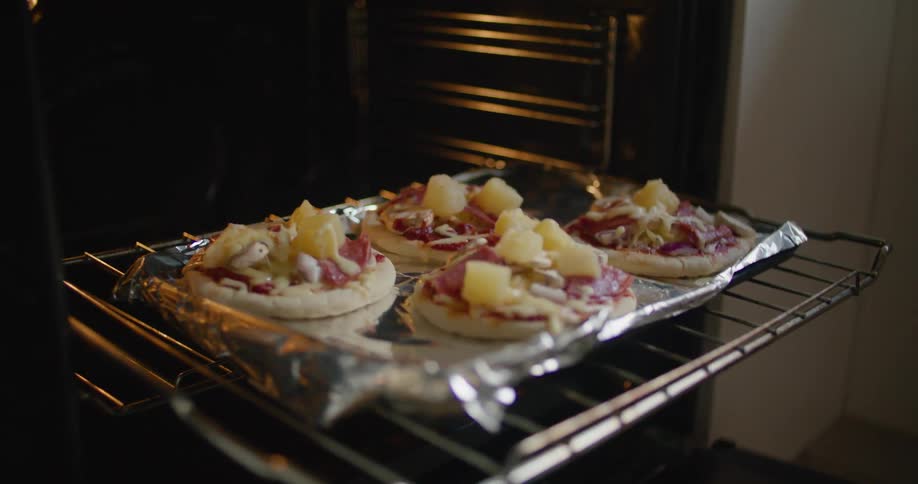 A person putting food in an oven