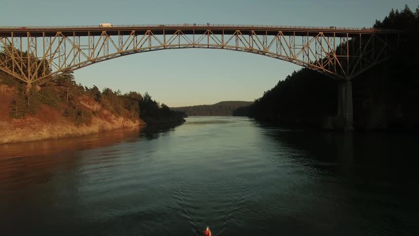 A large bridge is covering the water in the distance