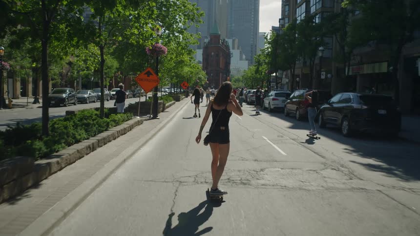 Group of young people riding skateboards on the streets of the city