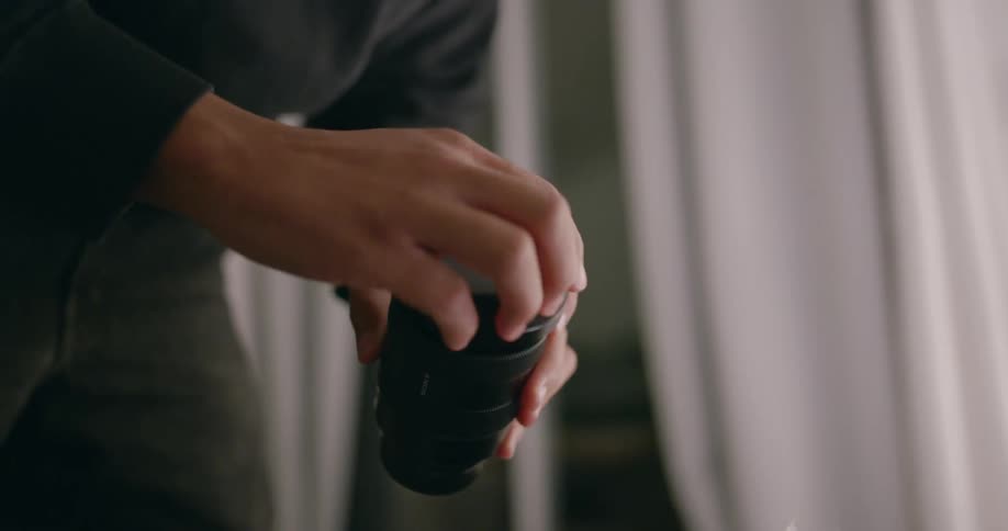 A person checking on camera gear in a carrying case