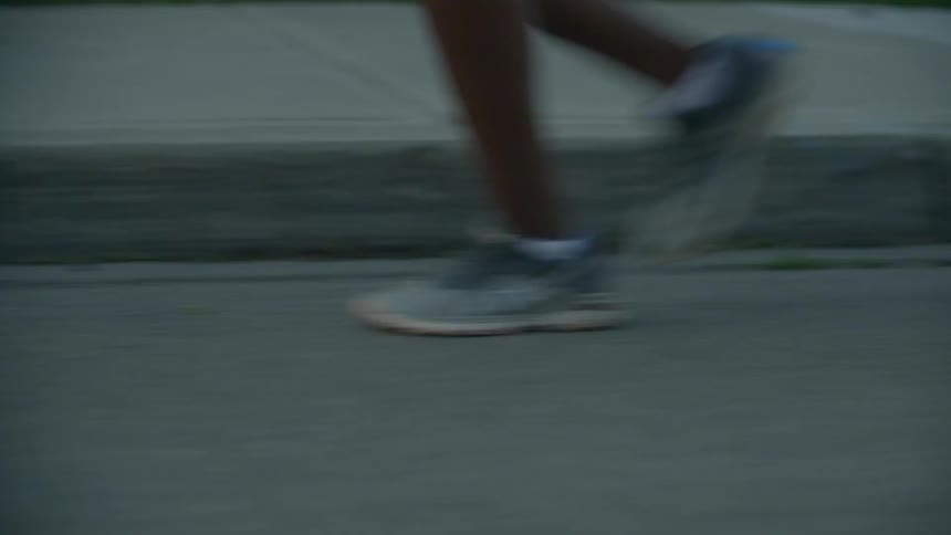 A woman jogging down a street