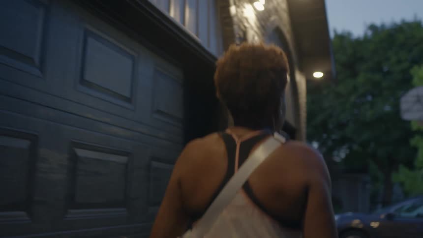 Woman walks out of house and gets in car parked in driveway